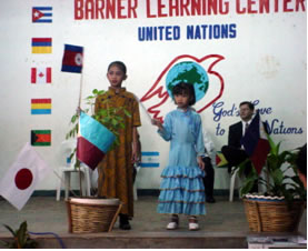 Two children on BLC stage. 276 BLC kids proudly prented facts, music & costumes from 30 countries on UN Day.