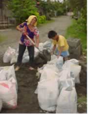 Bebing and son filling sacks.