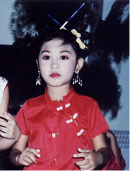 Pretty Philippino girl in red Chinese shirt.