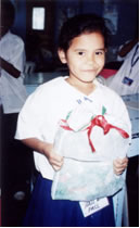 Smiling child holding wrapped gift